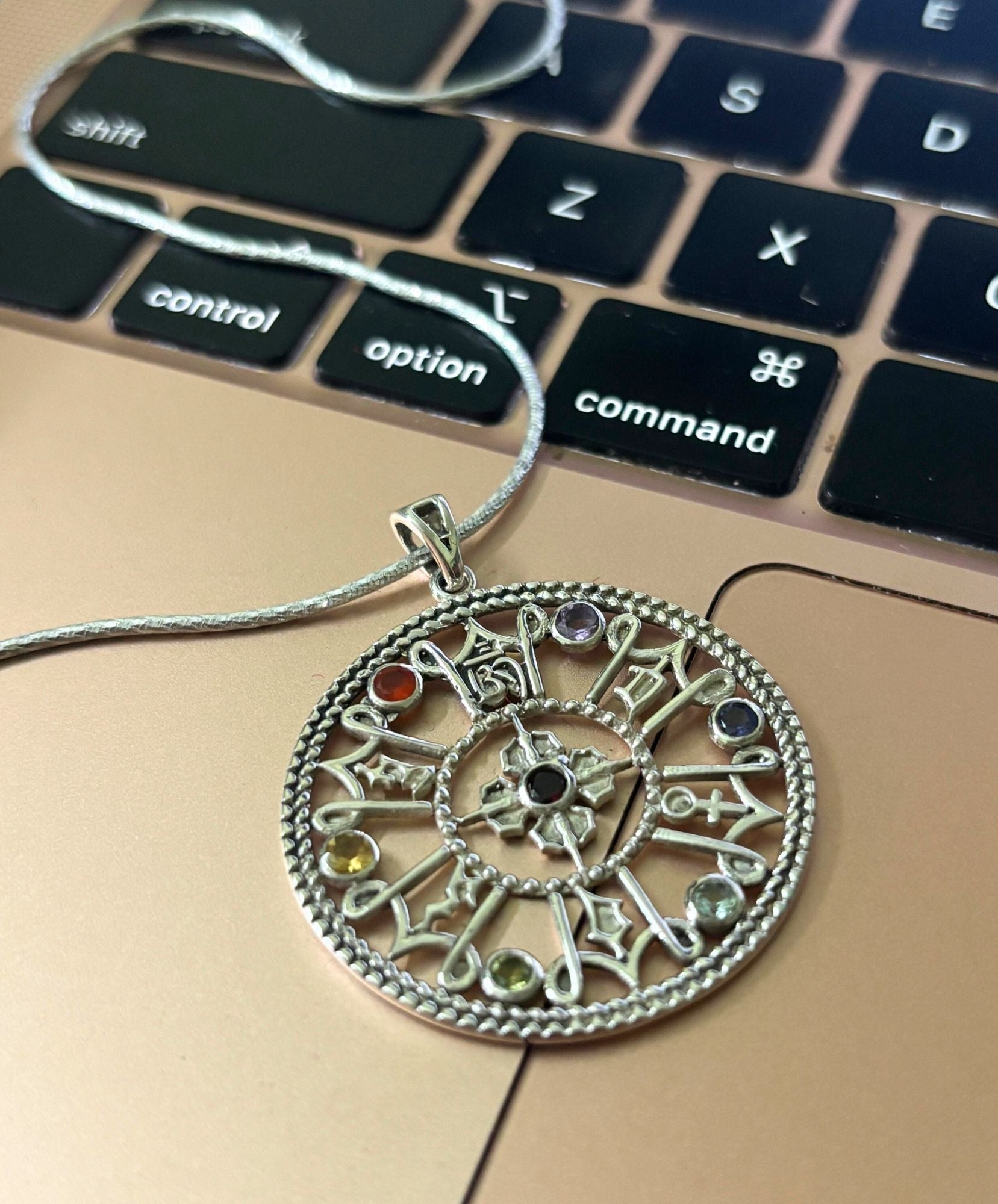 7 chakra inspired pendants with precious crystals set in 925 silver as metal.